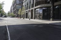 an empty street under a bridge that connects two buildings to the sidewalk and a sidewalk