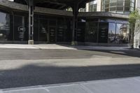 an empty street under a bridge that connects two buildings to the sidewalk and a sidewalk