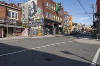 a street is littered with graffiti painted stores and small businesses that are vacant and empty