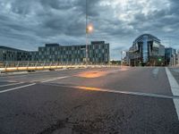 the city is empty during the evening with traffic on it and many buildings in the distance