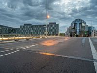 the city is empty during the evening with traffic on it and many buildings in the distance