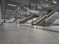 an empty subway with multiple steps down and no people around it as well as a banner about how to go