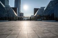 empty tiled floor in a large city area in the daytime sun light and blue sky