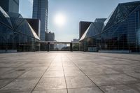 empty tiled floor in a large city area in the daytime sun light and blue sky