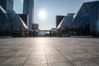 empty tiled floor in a large city area in the daytime sun light and blue sky