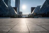 empty tiled floor in a large city area in the daytime sun light and blue sky