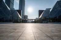 empty tiled floor in a large city area in the daytime sun light and blue sky