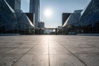 empty tiled floor in a large city area in the daytime sun light and blue sky