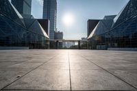 empty tiled floor in a large city area in the daytime sun light and blue sky