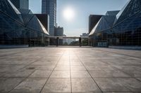 empty tiled floor in a large city area in the daytime sun light and blue sky