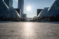 empty tiled floor in a large city area in the daytime sun light and blue sky