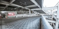 an empty and empty train station with signs in it and an arrow in the middle of the floor