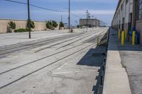 the long train track is empty on the side of the street and is ready to be used