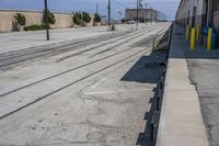 the long train track is empty on the side of the street and is ready to be used