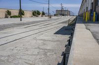 the long train track is empty on the side of the street and is ready to be used