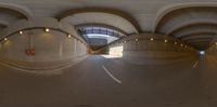 a 360 - view mirror shows an empty tunnel where the bike ride is going under a bridge