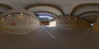 a 360 - view mirror shows an empty tunnel where the bike ride is going under a bridge