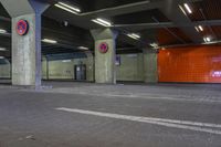 an empty underground parking lot with a sign on the wall saying no to pedestrians and one way