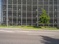 the road has cars driving on it, and is empty with signs for pedestrians to pass