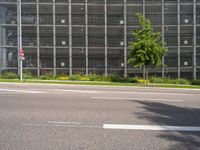 the road has cars driving on it, and is empty with signs for pedestrians to pass