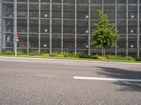 the road has cars driving on it, and is empty with signs for pedestrians to pass