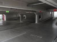 a parking garage with an empty walkway between the two spaces, which are marked with a line number one