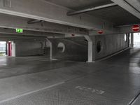 a parking garage with an empty walkway between the two spaces, which are marked with a line number one