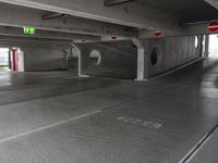 a parking garage with an empty walkway between the two spaces, which are marked with a line number one