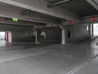 a parking garage with an empty walkway between the two spaces, which are marked with a line number one