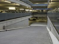 an empty walkway in an underground parking garage in the city of london, united kingdom of great britain