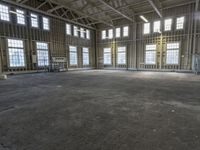 the empty warehouse has steel framing on all three floors and flooring it's gray