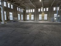 the empty warehouse has steel framing on all three floors and flooring it's gray