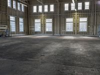 the empty warehouse has steel framing on all three floors and flooring it's gray