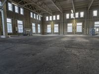 the empty warehouse has steel framing on all three floors and flooring it's gray