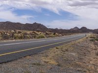 the yellow lines of a road running along side the mountain range are visible in this picture