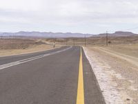 the desert is home to several motorcyclists riding down this long road with two lines