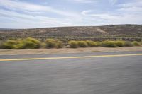 an image of a mountain range taken from a moving vehicle windshield as it drives down the road