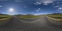 an empty road leading into the distance on a sunny day in the country side of iceland