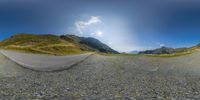 fish eye view of an empty asphalt road with a beautiful blue sky in the background