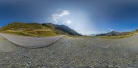 fish eye view of an empty asphalt road with a beautiful blue sky in the background