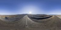 the 360 - pane shows several vehicles in a large barren area with high mountains in the background