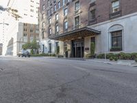 a view of the entrance to a large, brick building with a canopy that's over it