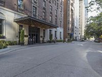 a view of the entrance to a large, brick building with a canopy that's over it