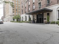 a view of the entrance to a large, brick building with a canopy that's over it