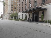 a view of the entrance to a large, brick building with a canopy that's over it