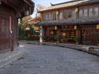 the entrance to a small shop with chinese lanterns hanging from the door and outside of it