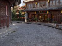 the entrance to a small shop with chinese lanterns hanging from the door and outside of it