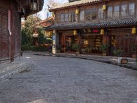 the entrance to a small shop with chinese lanterns hanging from the door and outside of it