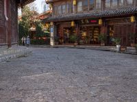 the entrance to a small shop with chinese lanterns hanging from the door and outside of it