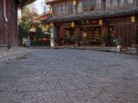 the entrance to a small shop with chinese lanterns hanging from the door and outside of it